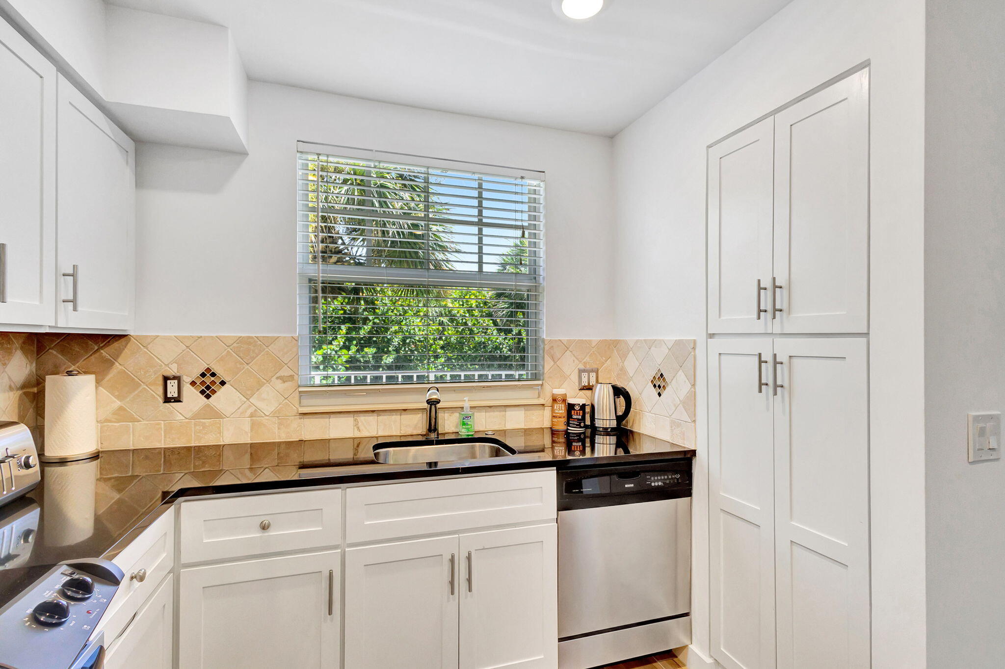 105 Mainsail Circle Jupiter, FL 33477 - Photo 21 of 85 a kitchen with a sink and cabinets