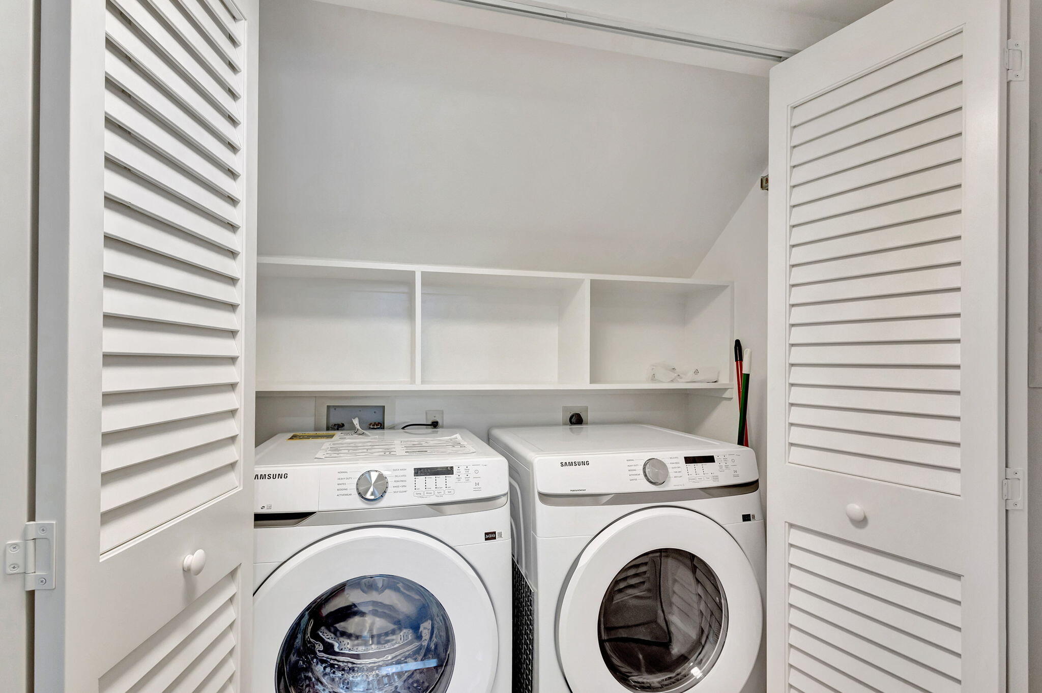 105 Mainsail Circle Jupiter, FL 33477 - Photo 30 of 85 a view of washer and dryer with kitchen in the background