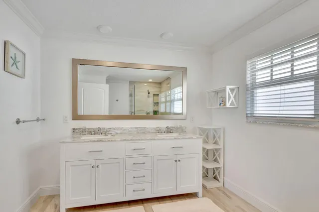 an aerial view of a house with outdoor space and trees all around