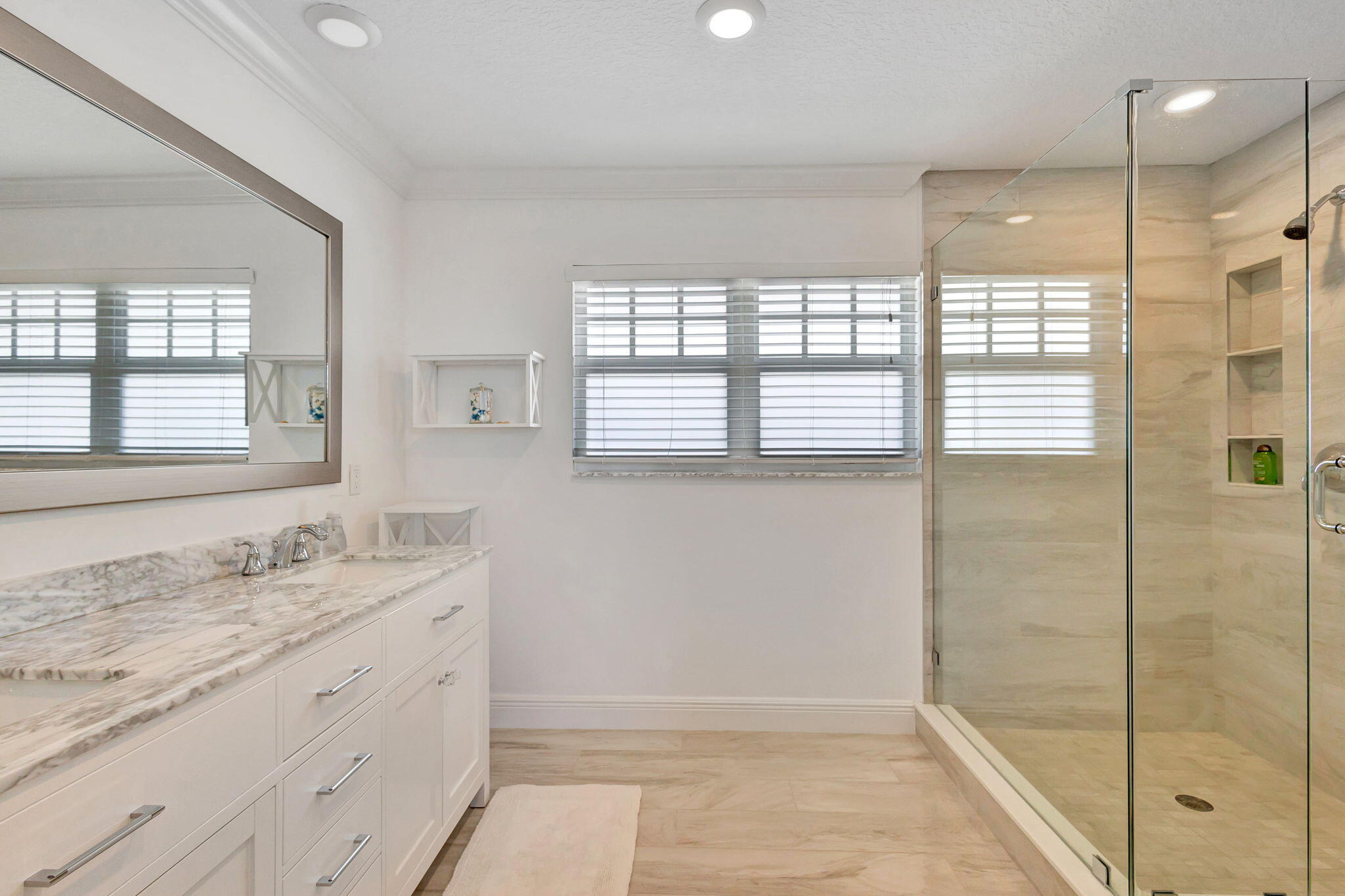 105 Mainsail Circle Jupiter, FL 33477 - Photo 43 of 85 a bathroom with a granite countertop sink a shower and a mirror