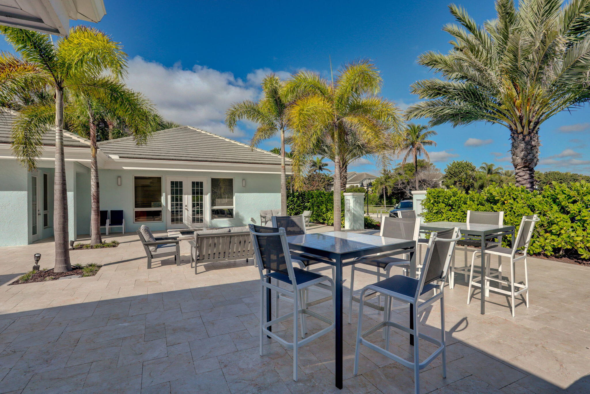 105 Mainsail Circle Jupiter, FL 33477 - Photo 49 of 85 a view of patio with a table and chairs and potted plants
