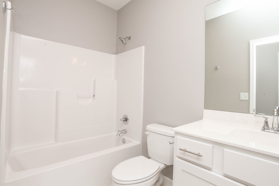 2935 Glendale Lane Normal, IL 61761 - Photo 17 of 29 a bathroom with a bathtub shower sink vanity mirror and toilet