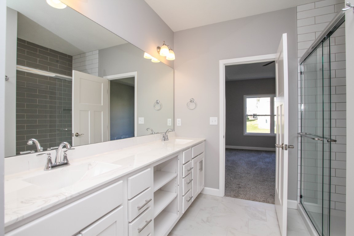 2935 Glendale Lane Normal, IL 61761 - Photo 24 of 29 a spacious bathroom with a double vanity sink mirror and shower