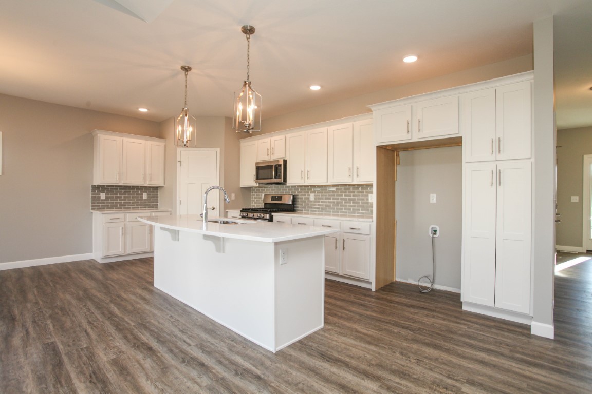 2935 Glendale Lane Normal, IL 61761 - Photo 5 of 29 a kitchen with stainless steel appliances granite countertop a refrigerator a sink dishwasher a stove and white cabinets with wooden floor