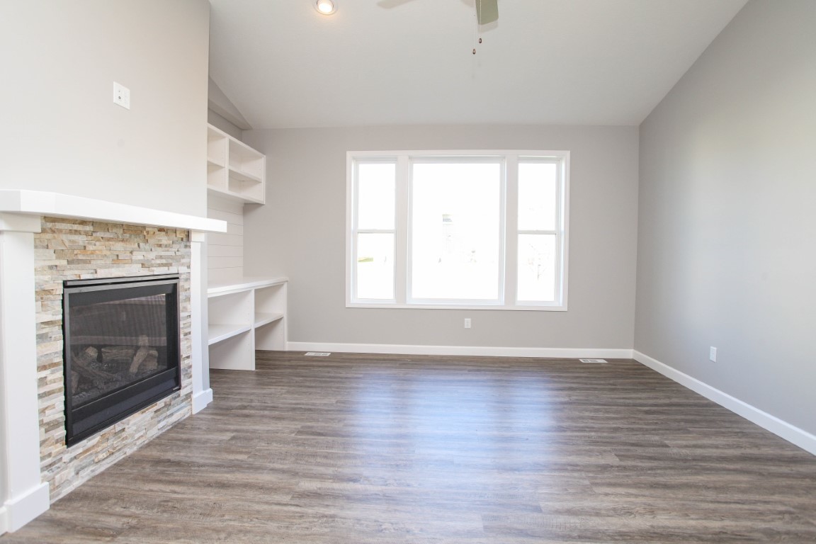 2935 Glendale Lane Normal, IL 61761 - Photo 9 of 29 an empty room with wooden floor fireplace and windows