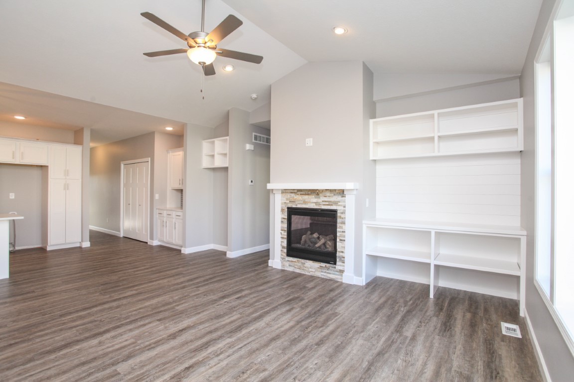 2935 Glendale Lane Normal, IL 61761 - Photo 10 of 29 a view of an empty room with a fireplace and a ceiling fan