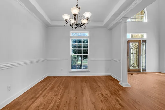 a view of a room with wooden floor and a window