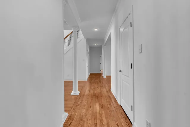 a view of a hallway with wooden floor