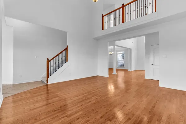 a living room with furniture and a book shelf