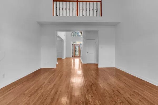 a view of an empty room with a fireplace and a window