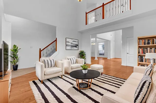 a living room with furniture and a book shelf