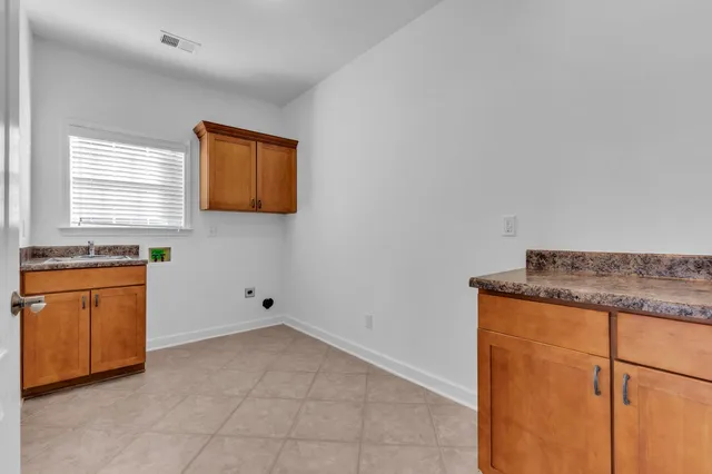 a kitchen with granite countertop cabinets stainless steel appliances a sink and a window