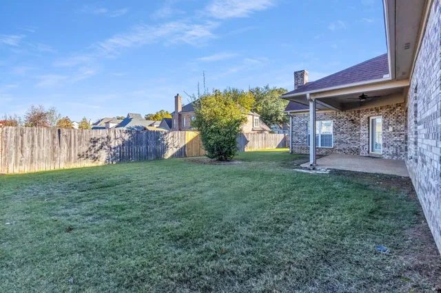 a view of a house with a yard and a fountain