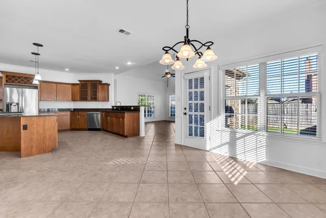a large kitchen with a large window cabinets and stainless steel appliances