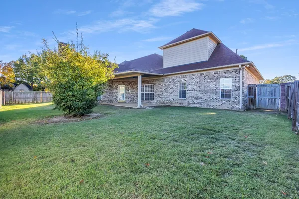 a kitchen with stainless steel appliances granite countertop a stove top oven a sink and a refrigerator