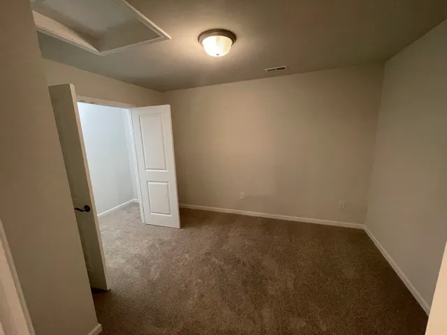 a view of an empty room and closet area