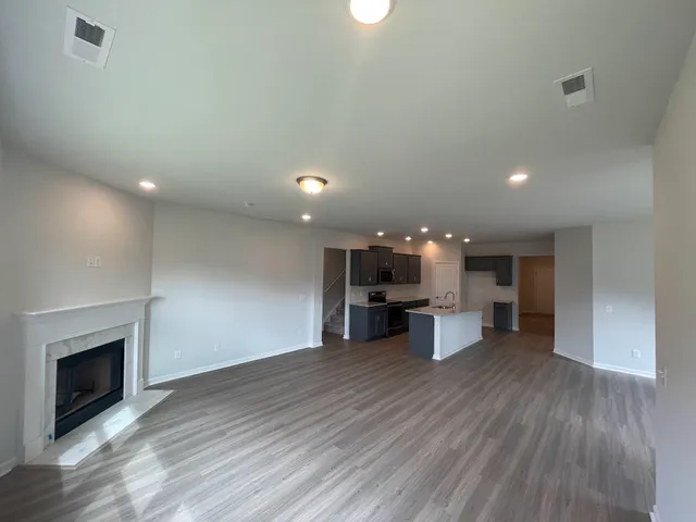 a view of a living room a kitchen and a fireplace