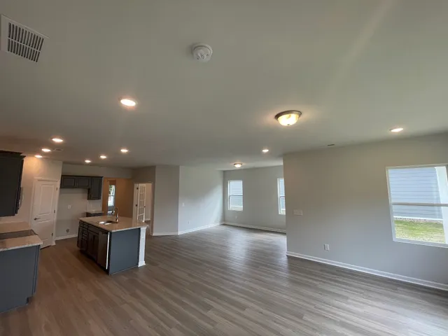 a view of kitchen with kitchen island microwave and wooden floor