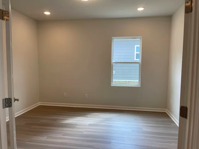a view of a room with wooden floor and window