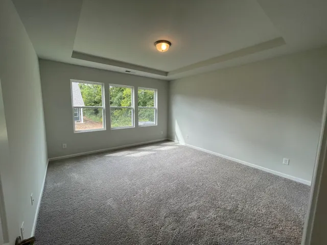 an empty room with windows and yard