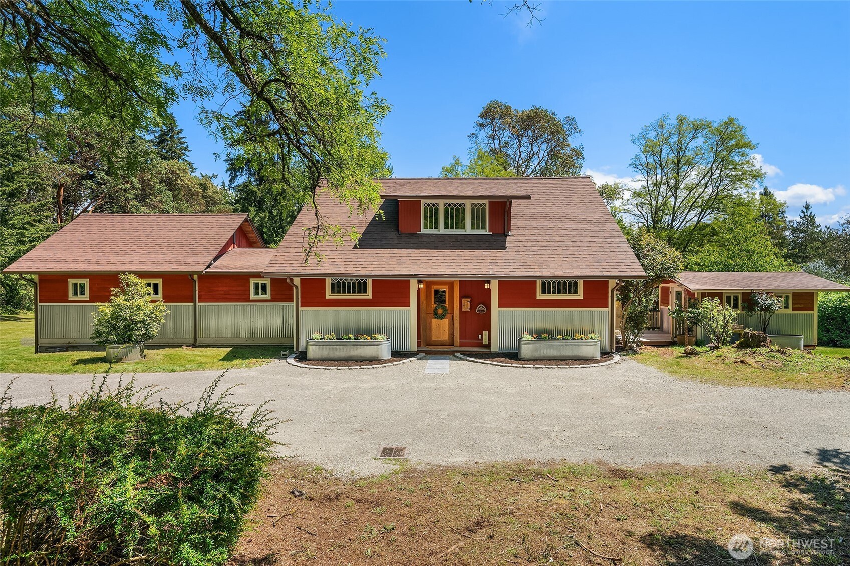19416 Beall Road Southwest Vashon, WA 98070 - Photo 1 of 40 a front view of a house with a yard and outdoor seating