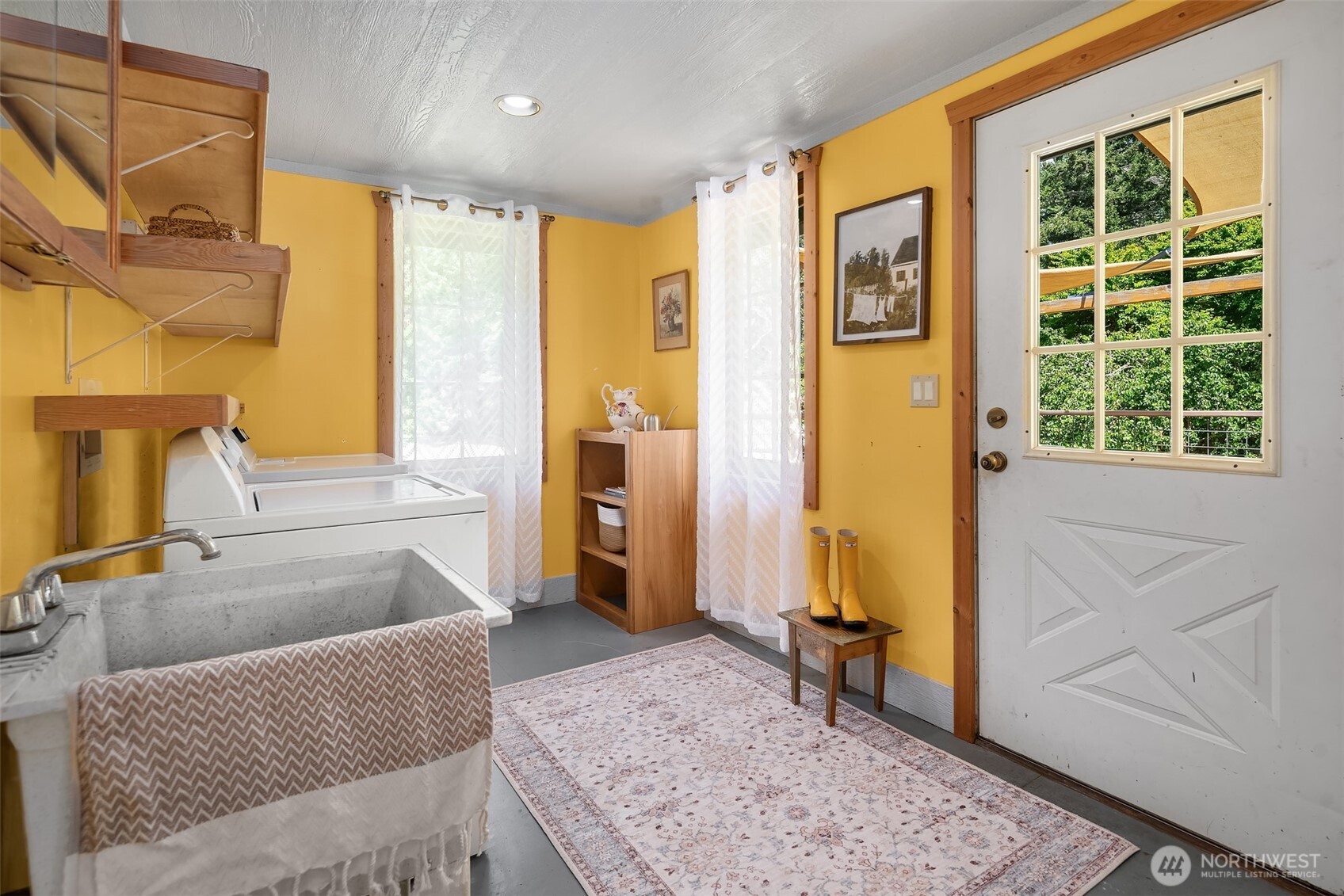 19416 Beall Road Southwest Vashon, WA 98070 - Photo 11 of 40 a bedroom with a bed and wooden floor
