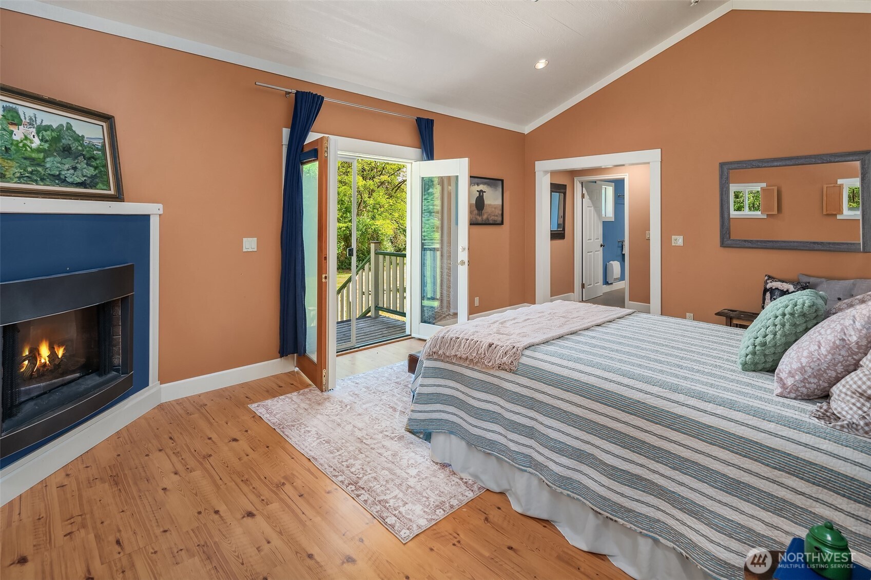 19416 Beall Road Southwest Vashon, WA 98070 - Photo 20 of 40 a bedroom with a bed and a fireplace