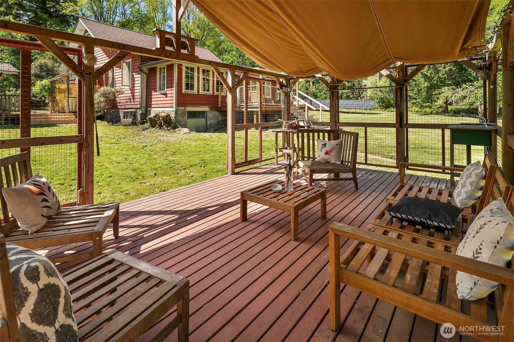19416 Beall Road Southwest Vashon, WA 98070 - Photo 34 of 40 a view of a patio with couches table chairs and wooden floor