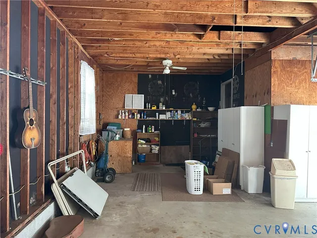 a sign that is sitting in front of a house with a small yard