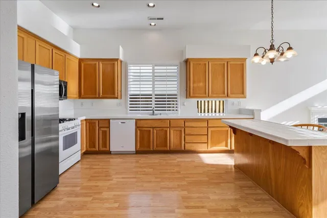 a dining room with a rug kitchen view and a counter top space