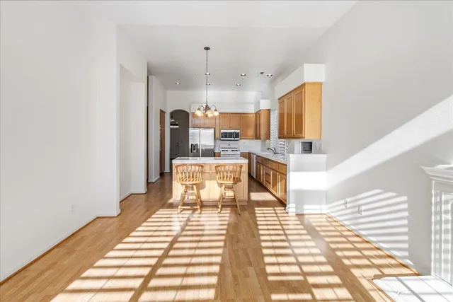 a view of an empty room with a fireplace and a window