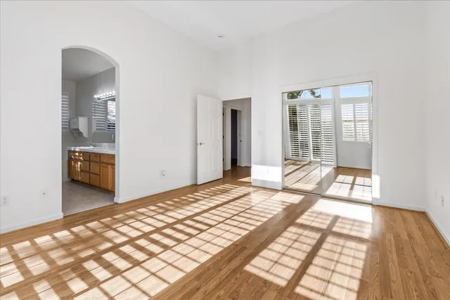 a bathroom with a granite countertop sink a mirror and a bathtub
