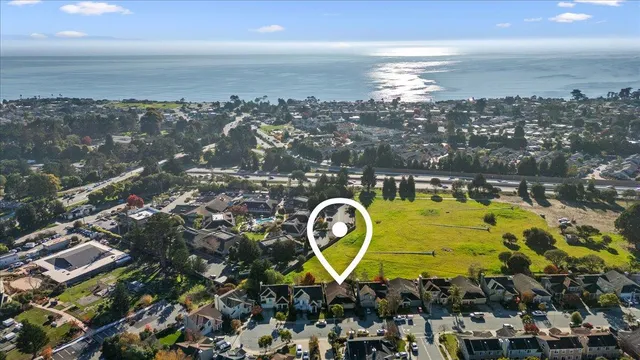 a front view of a house with a garden and plants