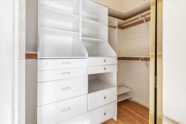 an empty room with wooden floor and a window