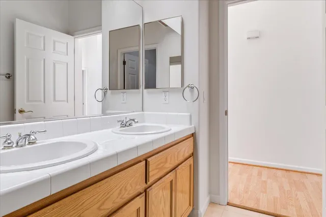 a white bath tub sitting next to a white wooden wall
