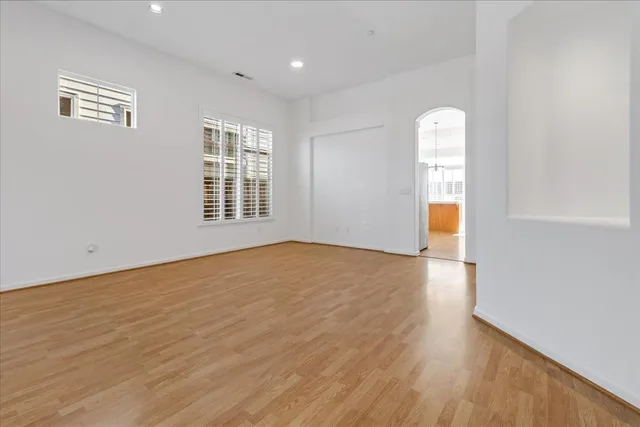 a kitchen with stainless steel appliances granite countertop a stove a sink and a wooden floors