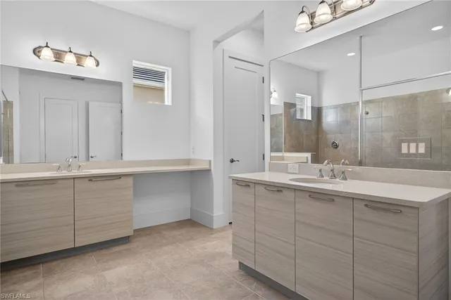 a bathroom with double sink and a mirror