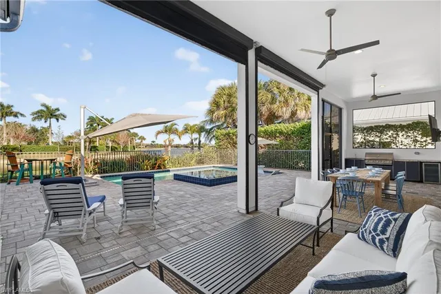 a living room with furniture and a floor to ceiling window