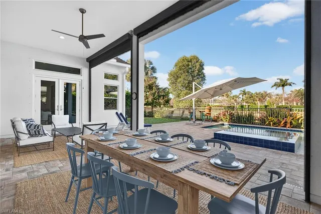 a view of a dining room with furniture large windows and wooden floor