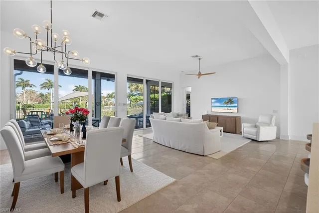 a living room with furniture fireplace and dining table
