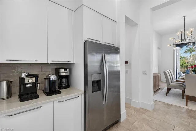 a kitchen with stainless steel appliances a refrigerator and cabinets