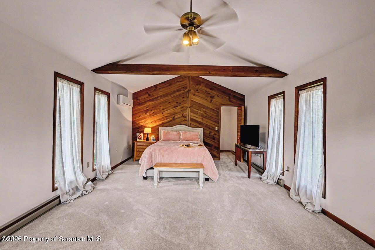 719 Scott Road Clarks Summit, PA 18411 - Photo 22 of 51 a bedroom with a bed and a chandelier