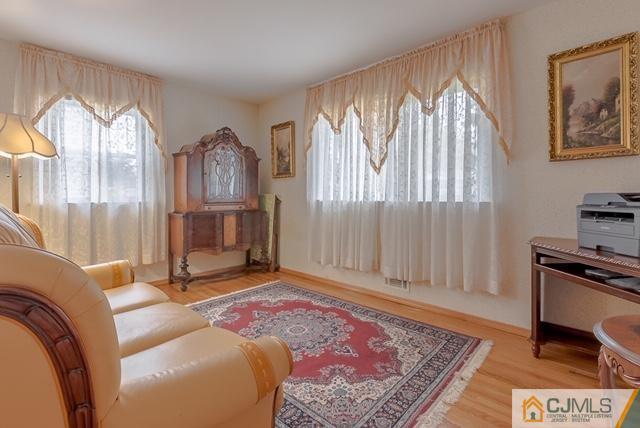 22 Kings Road East Brunswick, NJ 08816 - Photo 15 of 24 a living room with furniture and a fireplace