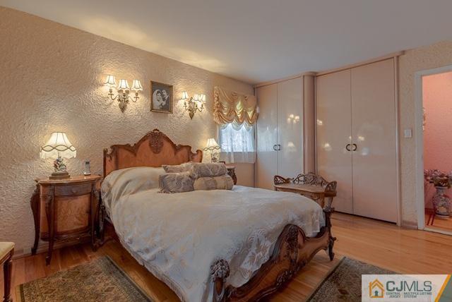 22 Kings Road East Brunswick, NJ 08816 - Photo 16 of 24 a bedroom with a bed and a chandelier