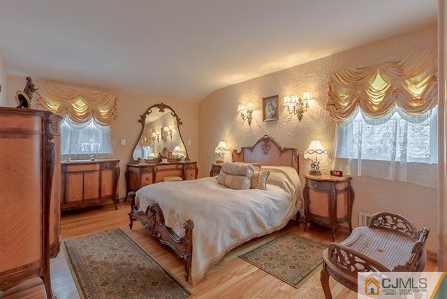 22 Kings Road East Brunswick, NJ 08816 - Photo 17 of 24 a bedroom with a bed a mirror and lamp on desk