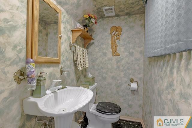 22 Kings Road East Brunswick, NJ 08816 - Photo 22 of 24 a bathroom with a sink toilet and mirror