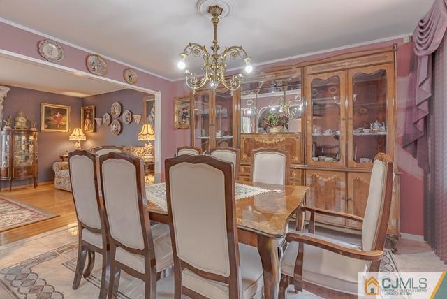 22 Kings Road East Brunswick, NJ 08816 - Photo 6 of 24 a view of a dining room with furniture and chandelier