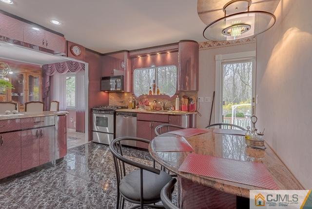 22 Kings Road East Brunswick, NJ 08816 - Photo 10 of 24 a kitchen with a table chairs sink and cabinets