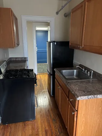 a kitchen with a sink and a refrigerator
