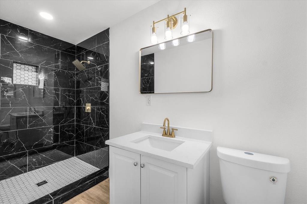 3301 Hedrick Street Fort Worth, TX 76111 - Photo 11 of 22 a bathroom with a sink and a mirror